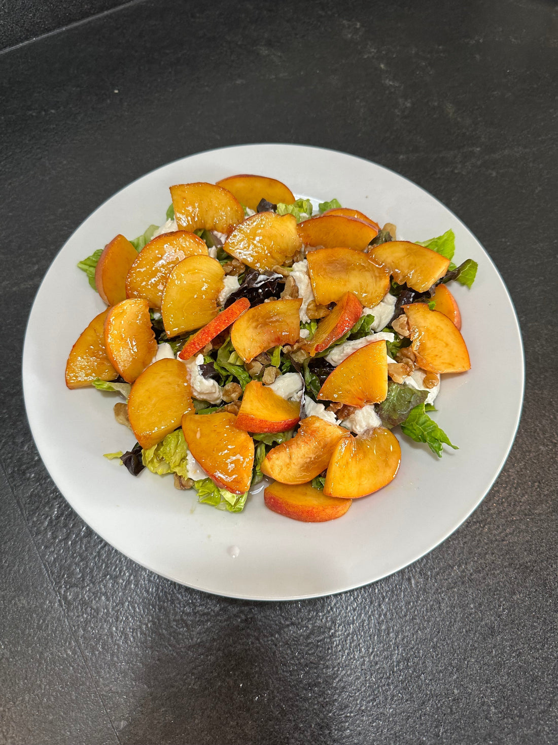The Peach & Burrata Salad with Lavender Vinaigrette is the perfect balance of sweet, savory, and aromatic, with juicy, ripe peaches, creamy burrata or mozzarella, crisp greens, and crunchy toasted nuts.